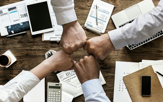 business people fist bumping